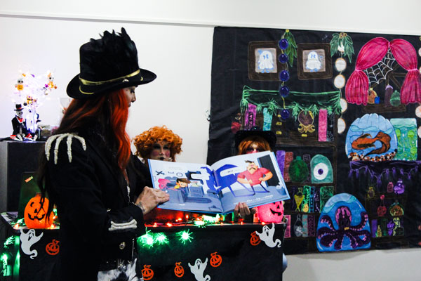 Drag Queen in costume reading a story.